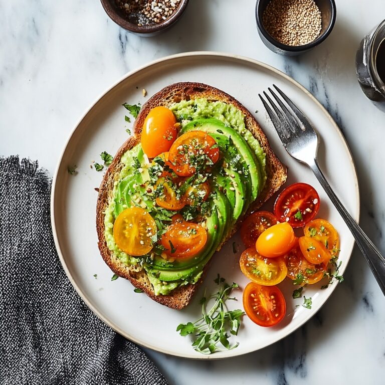 Creamy Avocado Toast with Cherry Tomatoes, Feta, and Basil Recipe